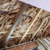 Acoustic tape being used in loft insulation.