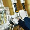Placing Aluminium foil tape around insulation.