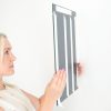 Galago double sided tape being applies to a wall