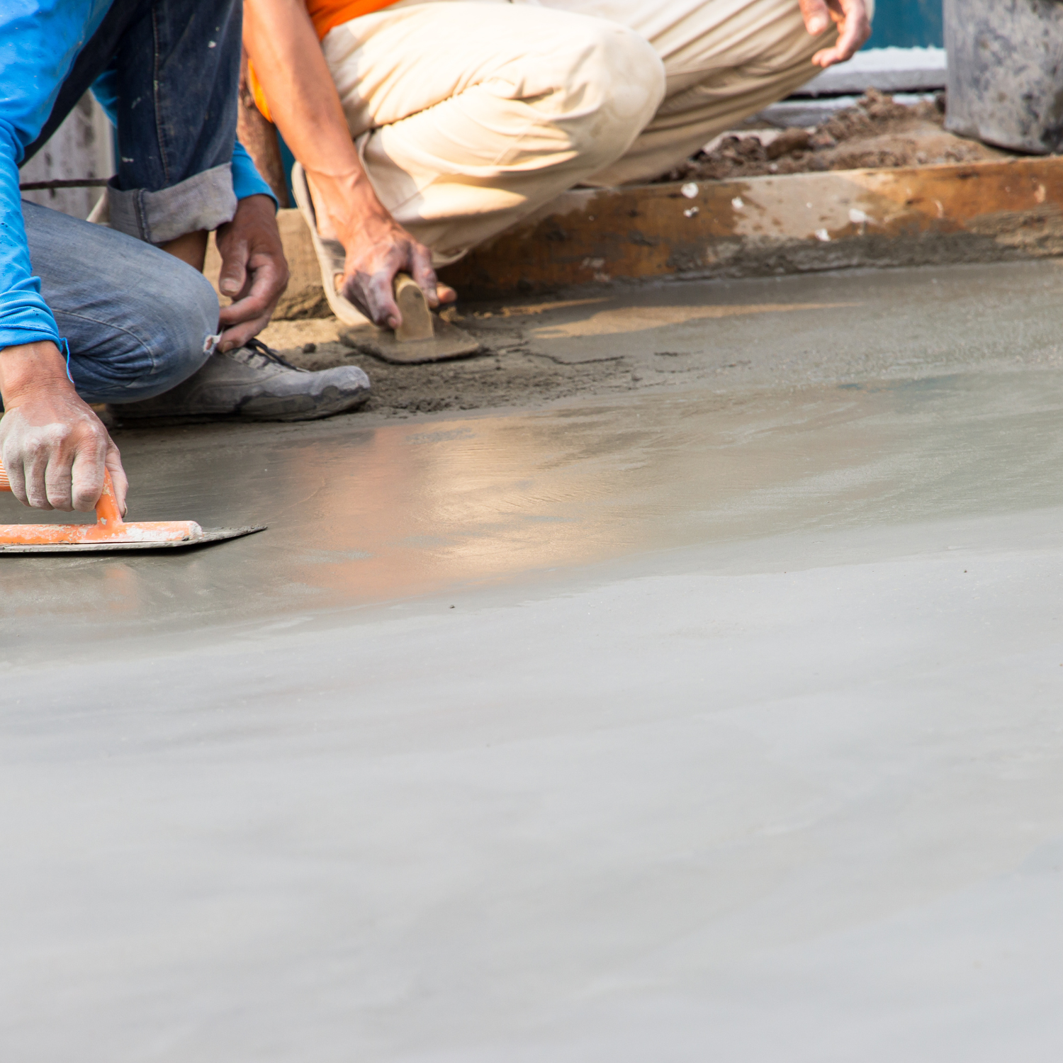 An image of cement being laid down onto a ground floor