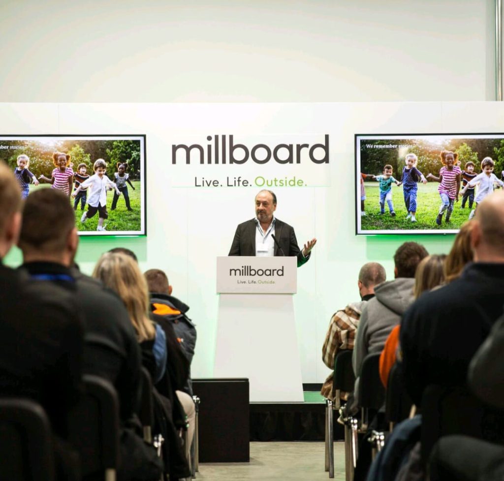 A speaker talking to an audience about Millboard products.
